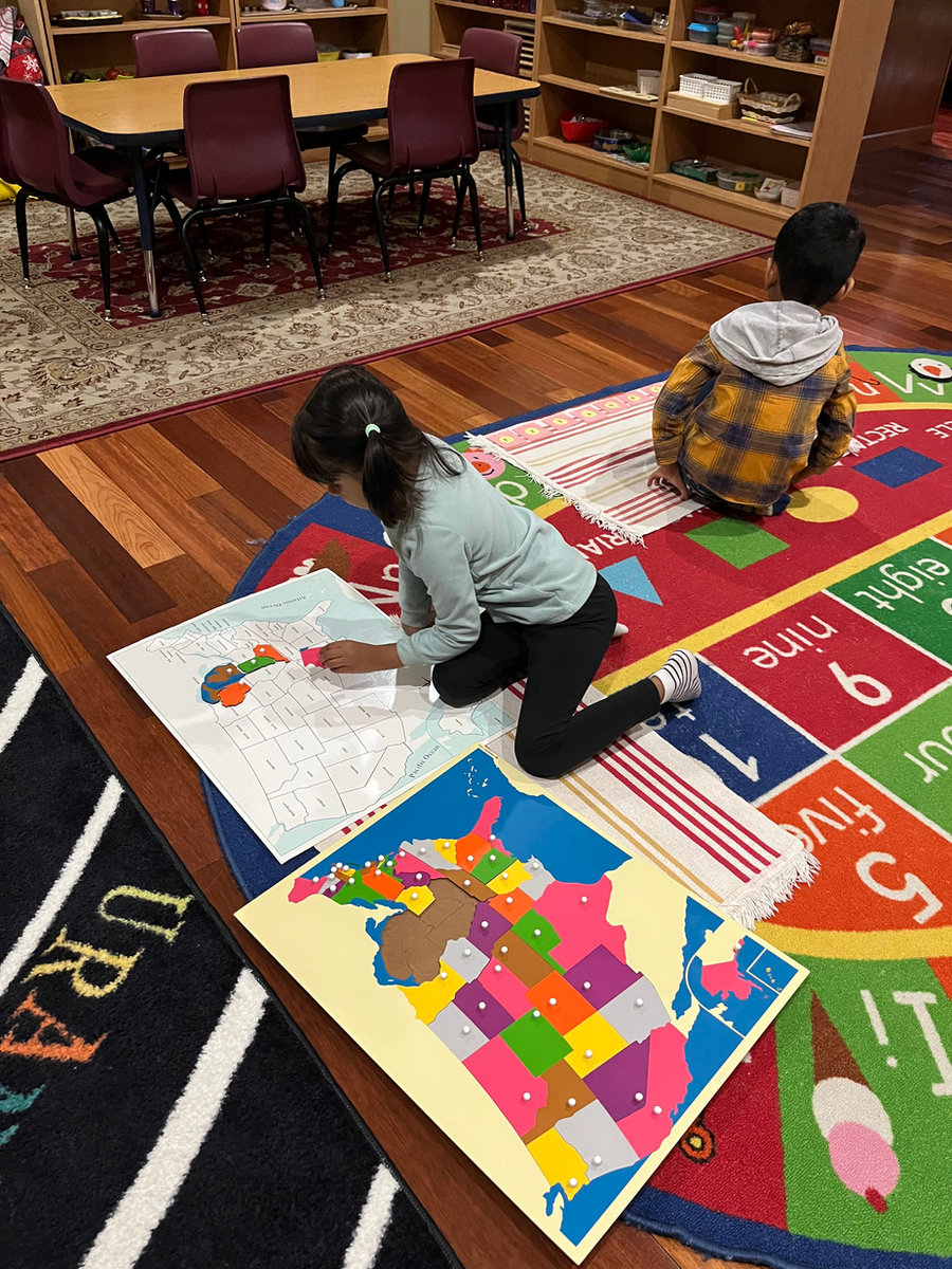 Children exploring geography with hands-on Montessori materials